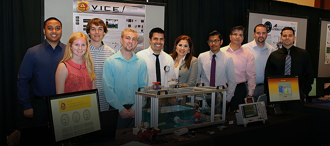 A group of electrical &amp;amp;amp; computer engineering students stand in front of their team project display